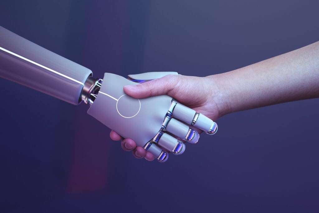 Image symbolically showing the bottom-line of artificail intelligence: a robot and a human shaking hand